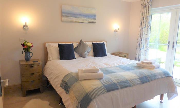 Bedroom 3 (ground floor) with superking size bed or 2x single beds and a smart TV.  Adjoining is an ensuite room with walk in shower.  This bedroom ha